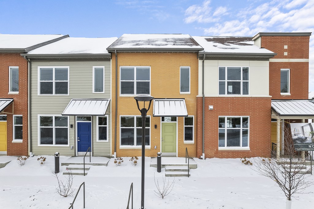 a row of houses in the snow