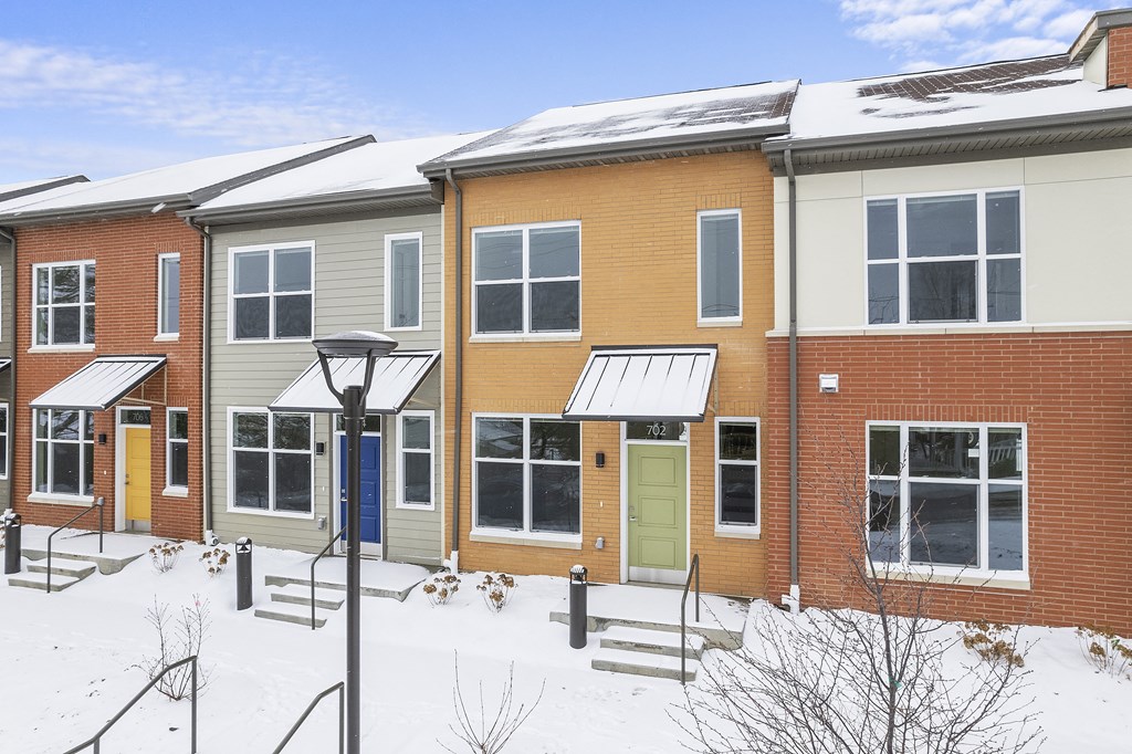 a row of houses in the snow