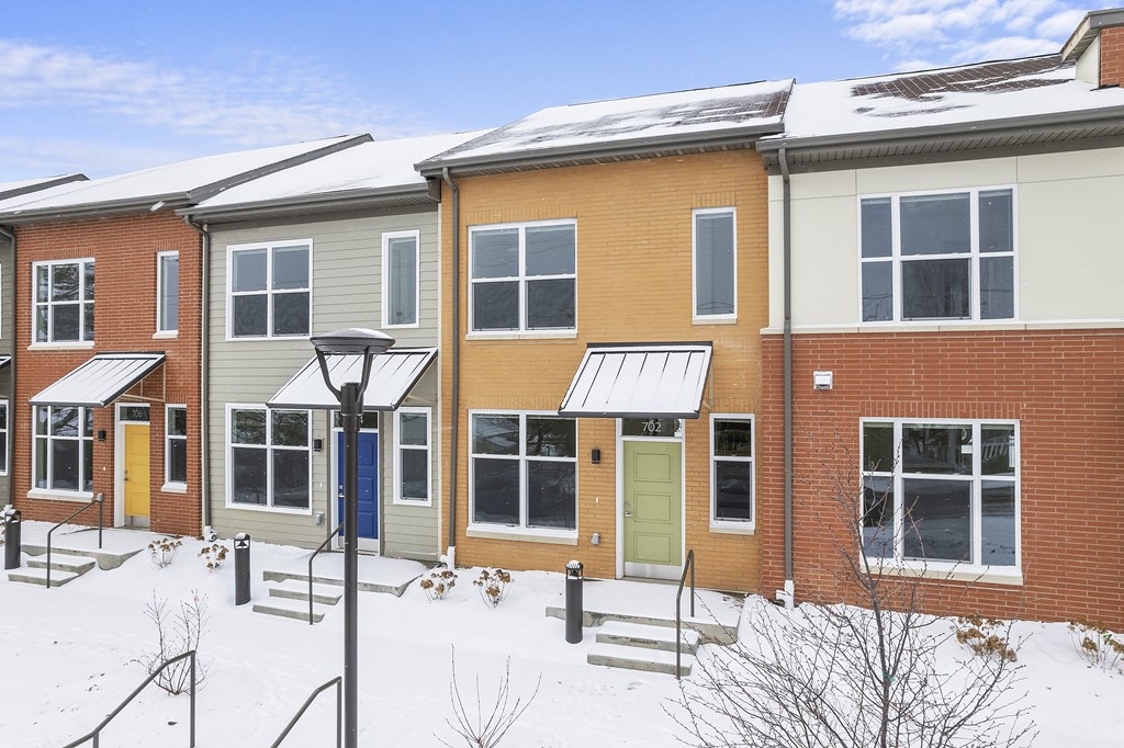 a row of houses in the snow