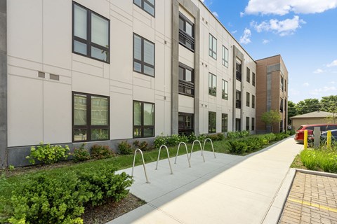 a large white building with a sidewalk in front of it