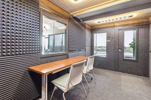 A conference room with a wooden table and two chairs.