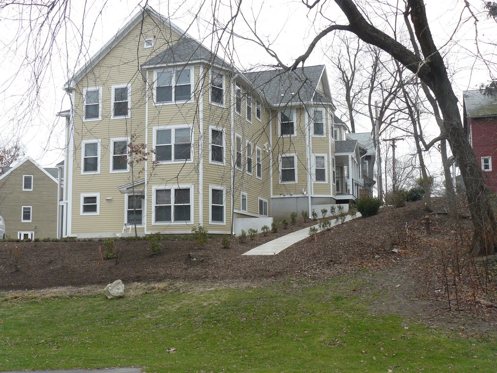 A large two-story house with a grey roof and white trim.