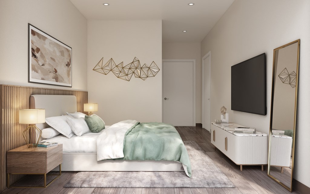 a bedroom with a bed and a tv on the wall