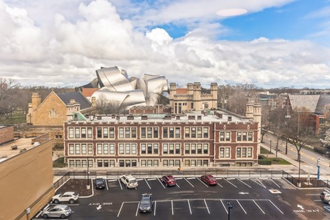 A modern building is situated in front of a traditional building.