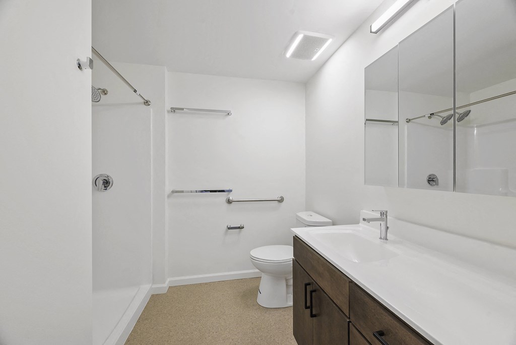 a bathroom with a sink toilet and a shower