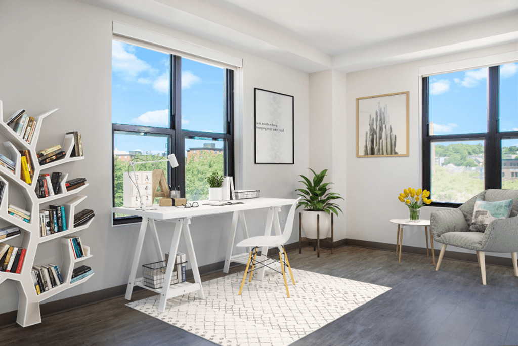 a home office with a white desk and a large window
