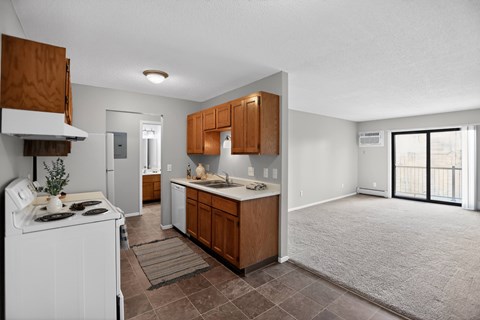 A kitchen with brown cabinets and a white stove.