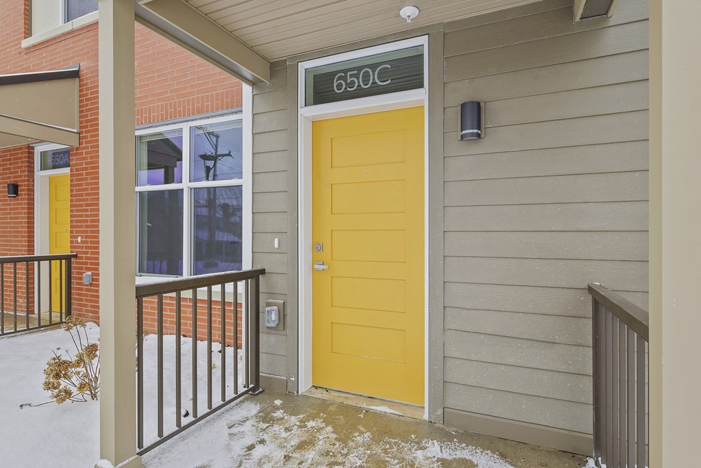 the front door of a house with a yellow door