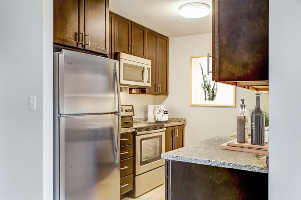 a kitchen with stainless steel appliances and granite counter tops