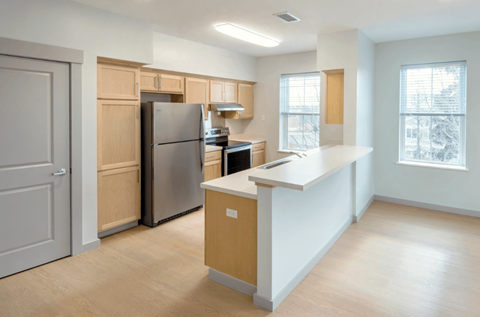 A kitchen with a refrigerator, stove, and oven.