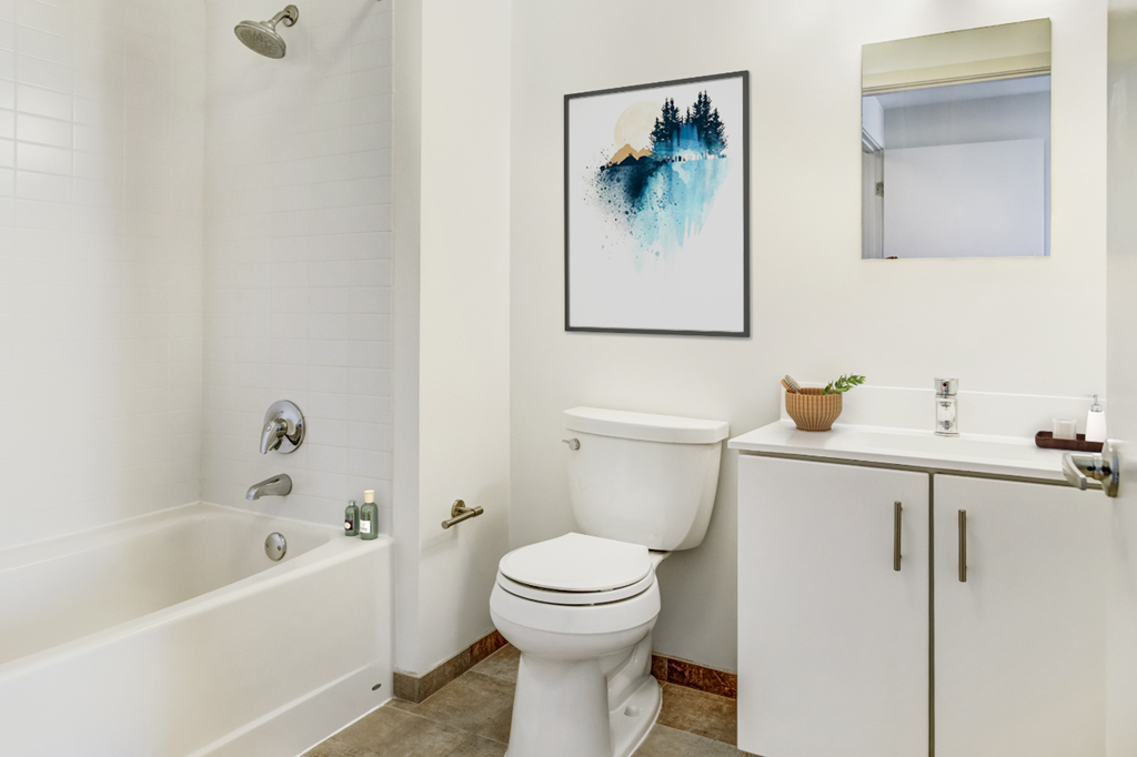 a bathroom with a toilet and a tub and a sink