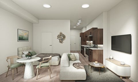 A modern living room with a white couch and a television on the wall.