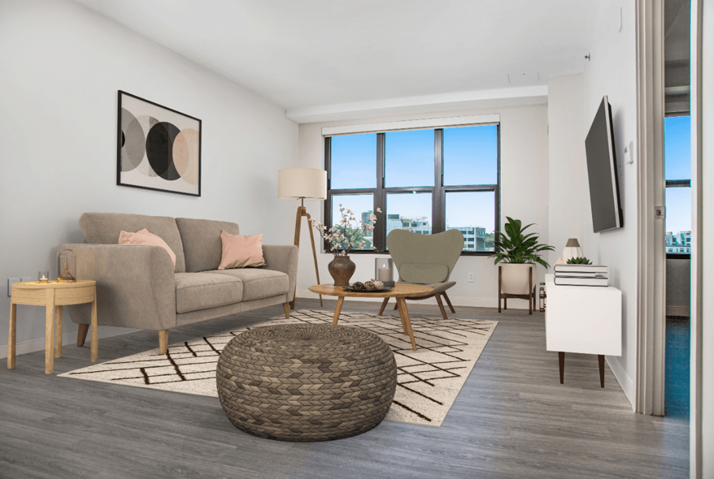 a living room with a couch and a chair and a window