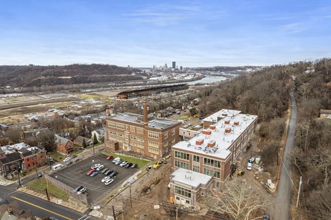 an aerial view of a city with buildings and a river