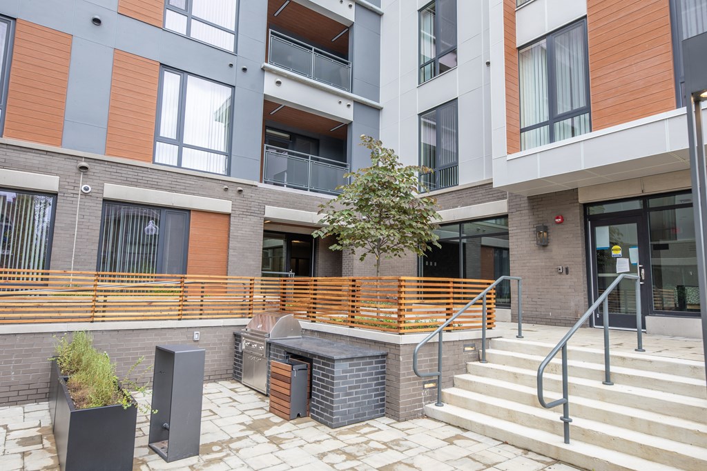 A modern building with a tree in a planter box.