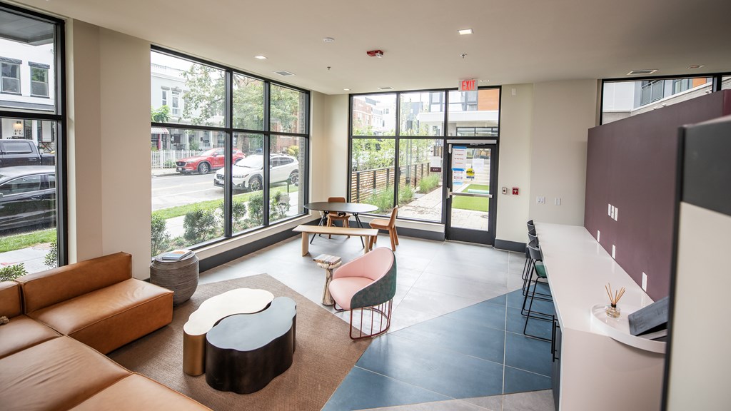 A large room with a couch, chairs, and a table.