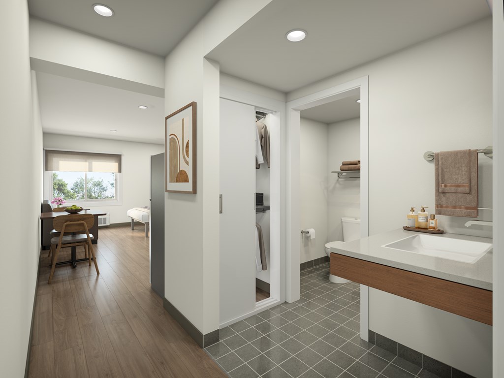 A bathroom with a wooden floor and a white sink.