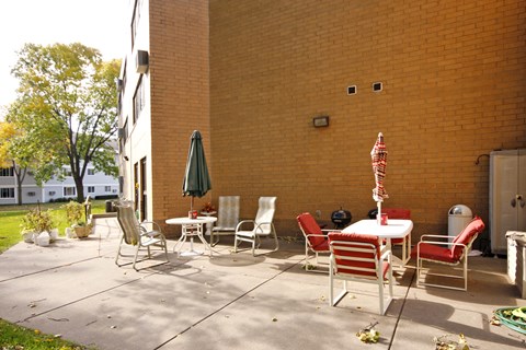 A patio with a table and chairs.
