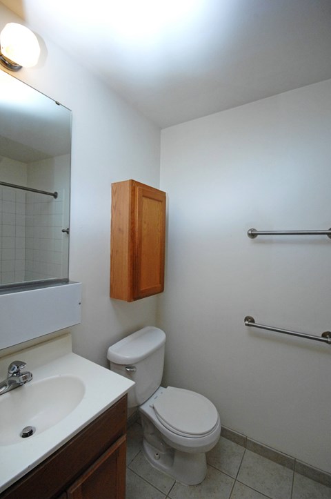 A white toilet sits next to a sink in a small bathroom.