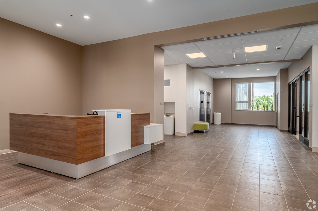a lobby with a reception desk and a window