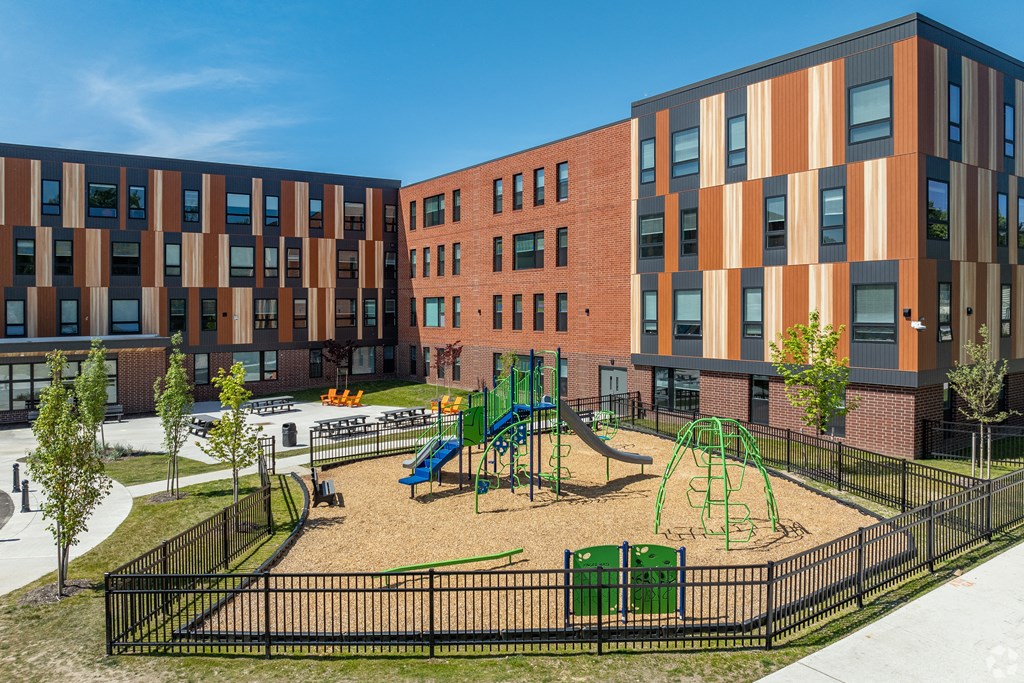 a playground in a courtyard in front of a building