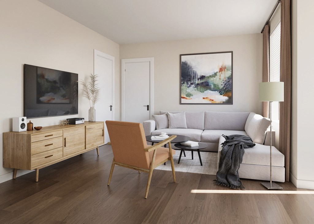 a living room with hardwood floors and white walls