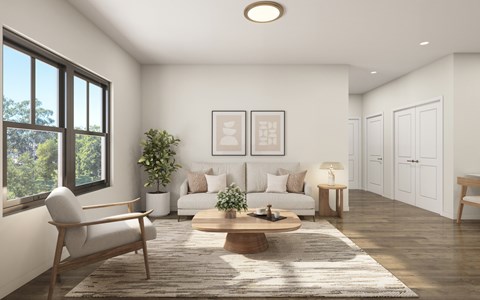 A living room with a sofa, a chair, a coffee table, and a potted plant.