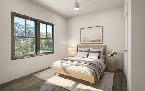 A bedroom with a large bed and a window overlooking a green landscape.