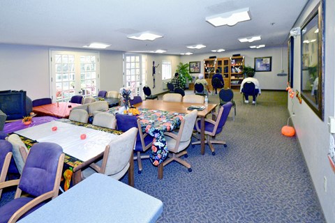A conference room with a long table and chairs.