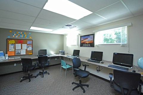 A room with a white ceiling and a bulletin board on the wall.