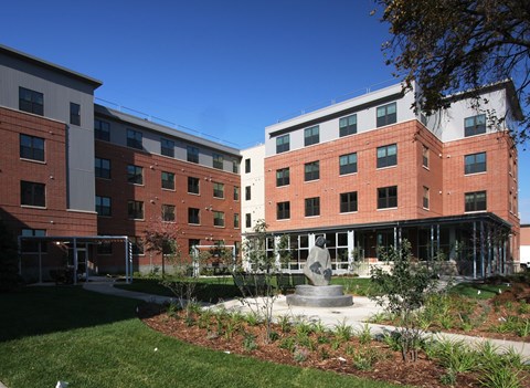 A modern building with a courtyard in front.