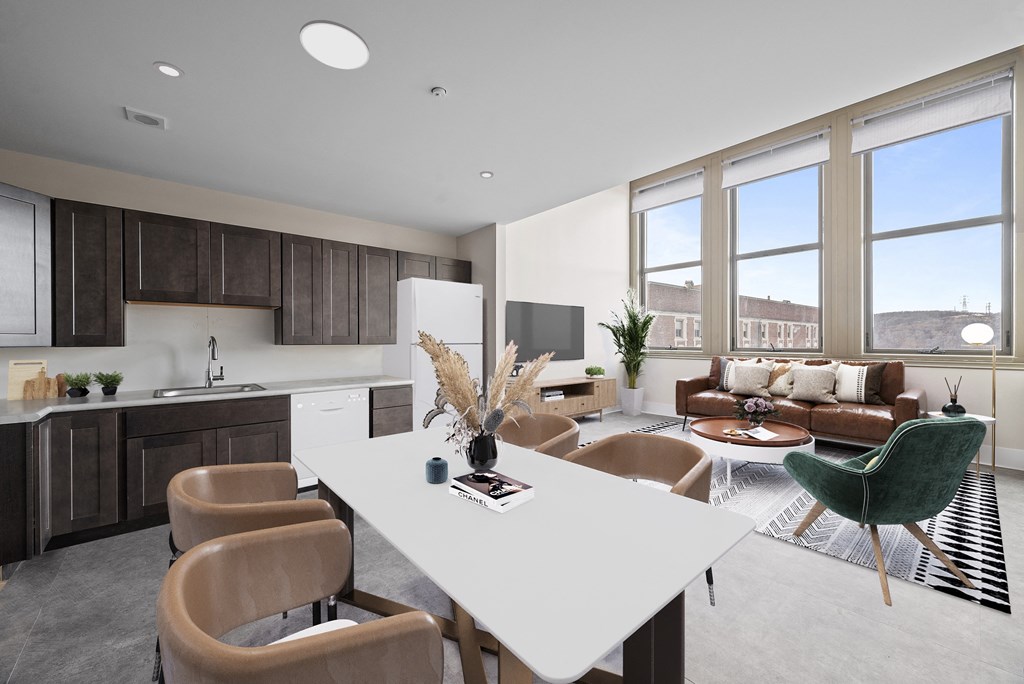 a living room and kitchen with a white table and chairs