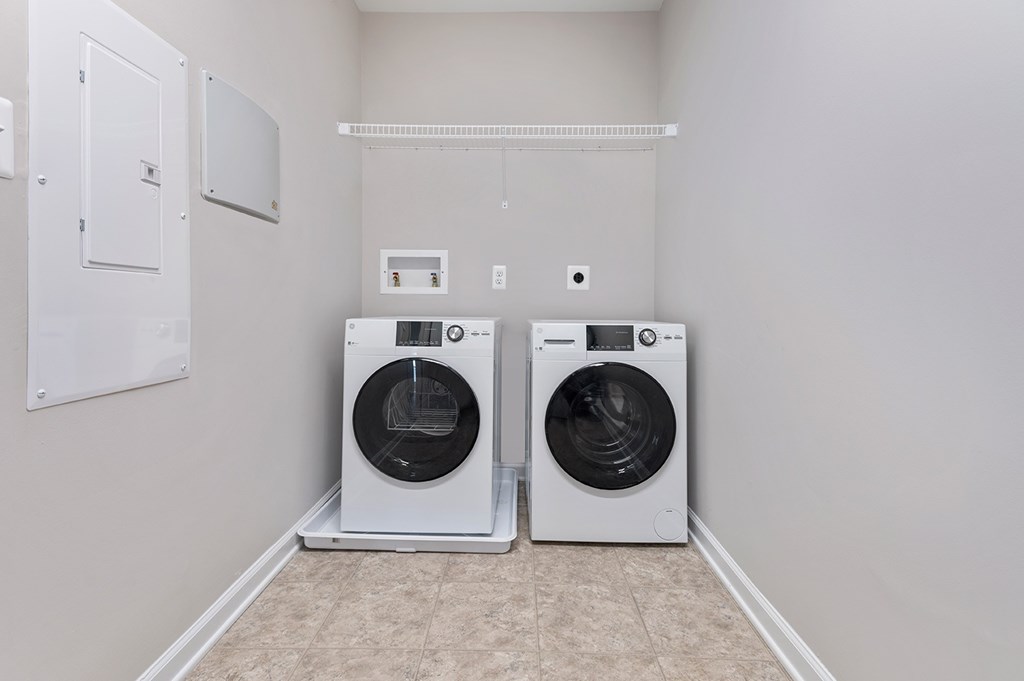 Two front loading washing machines in a laundry room.