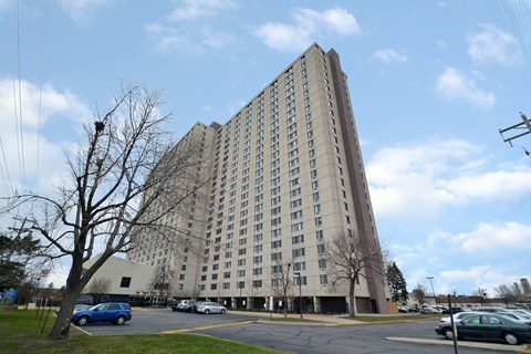 A large building with a parking lot in front.