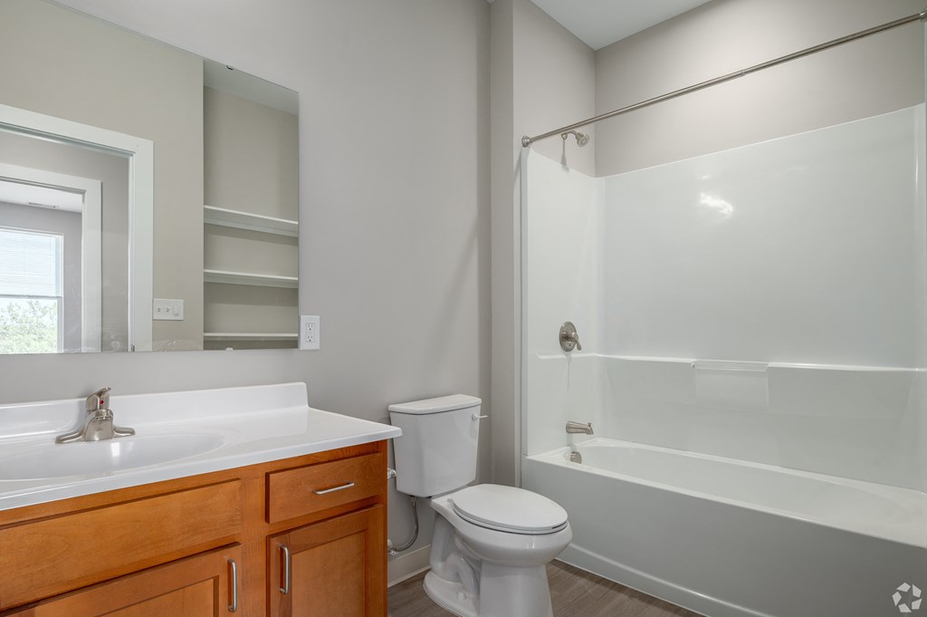 an empty bathroom with a shower toilet and sink