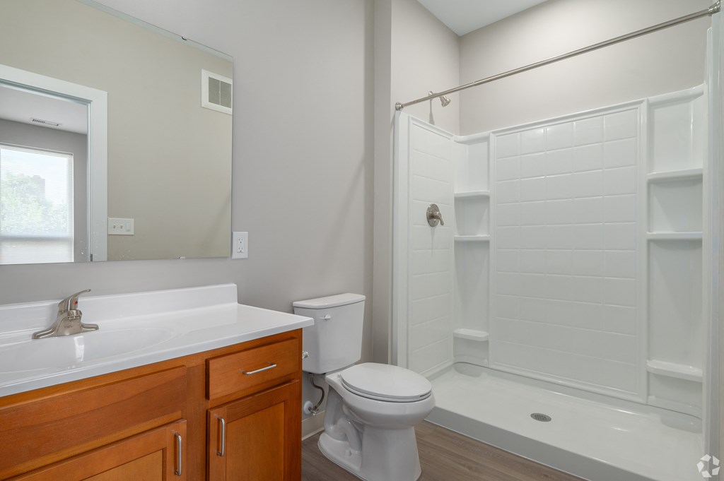 an empty bathroom with a shower toilet and sink
