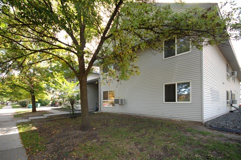 A house with a tree in front of it.