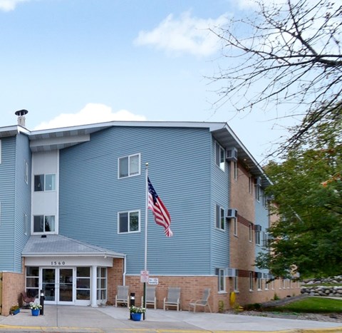 A blue building with an American flag on top of a pole.