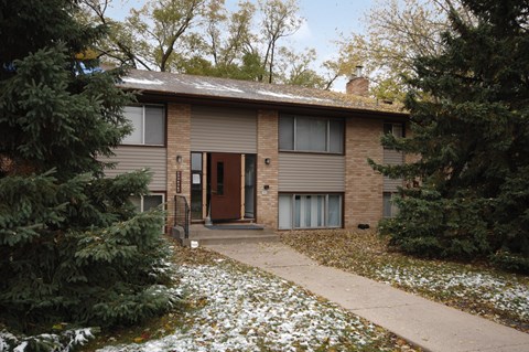 A house with a brown door and a brown roof.