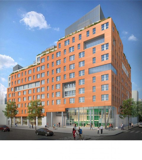 A modern orange building with a green roof and a glass facade.