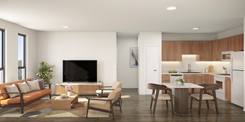 A modern living room with a brown sofa, a wooden coffee table, and a kitchen area in the background.
