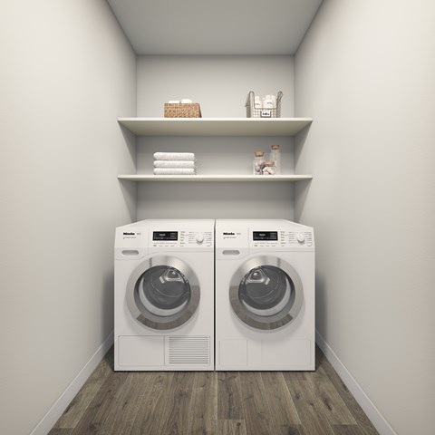 Two front loading washing machines in a laundry room.