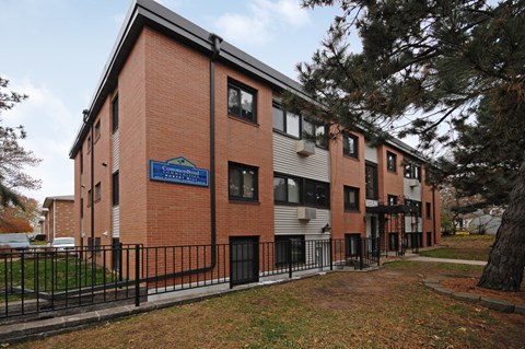 A brick building with a blue sign in front of it.