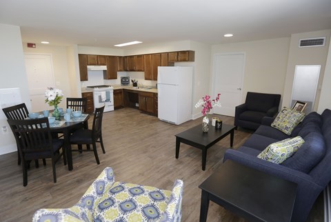 A living room with a dining table and chairs.