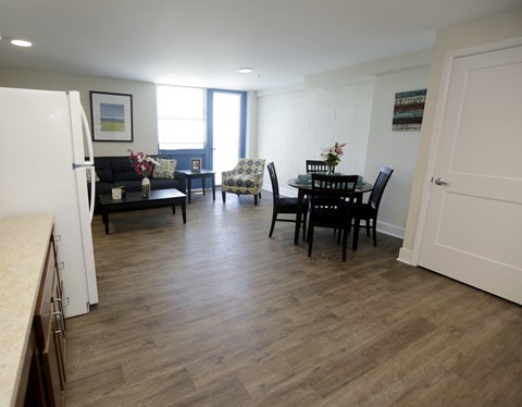 A kitchen with a dining table and chairs.