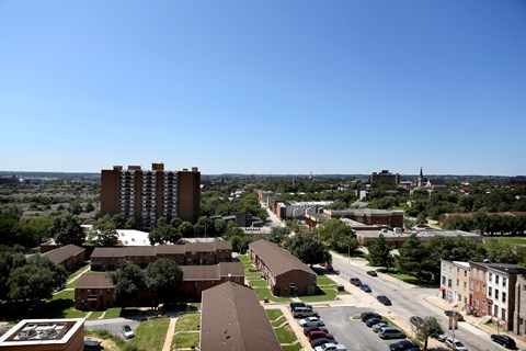 A view of a city with a large building in the middle of the frame.
