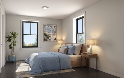 A bedroom with a bed, nightstand, and a plant.
