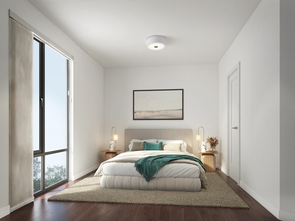 a bedroom with white walls and a bed with a green blanket