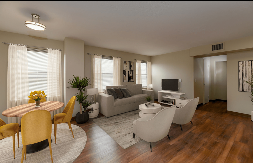 A living room with a wooden floor and furniture.