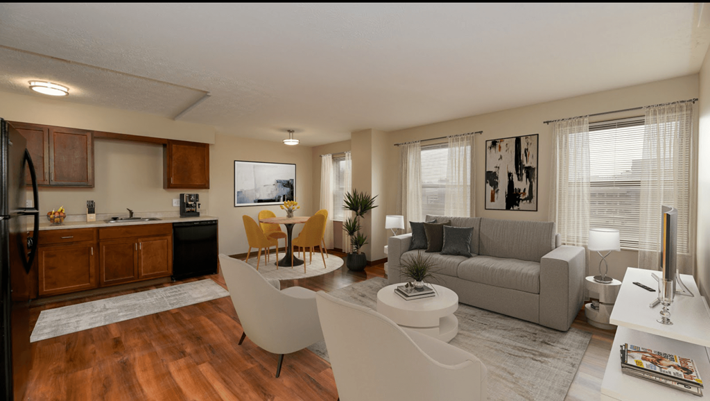 A modern living room with a kitchen area in the background.
